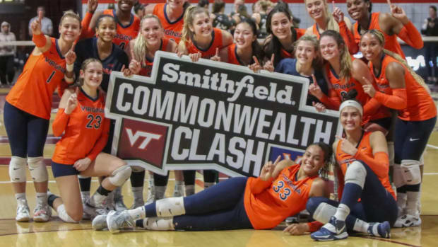 The Virginia volleyball team celebrates its victory over Virginia Tech at Cassell Coliseum.